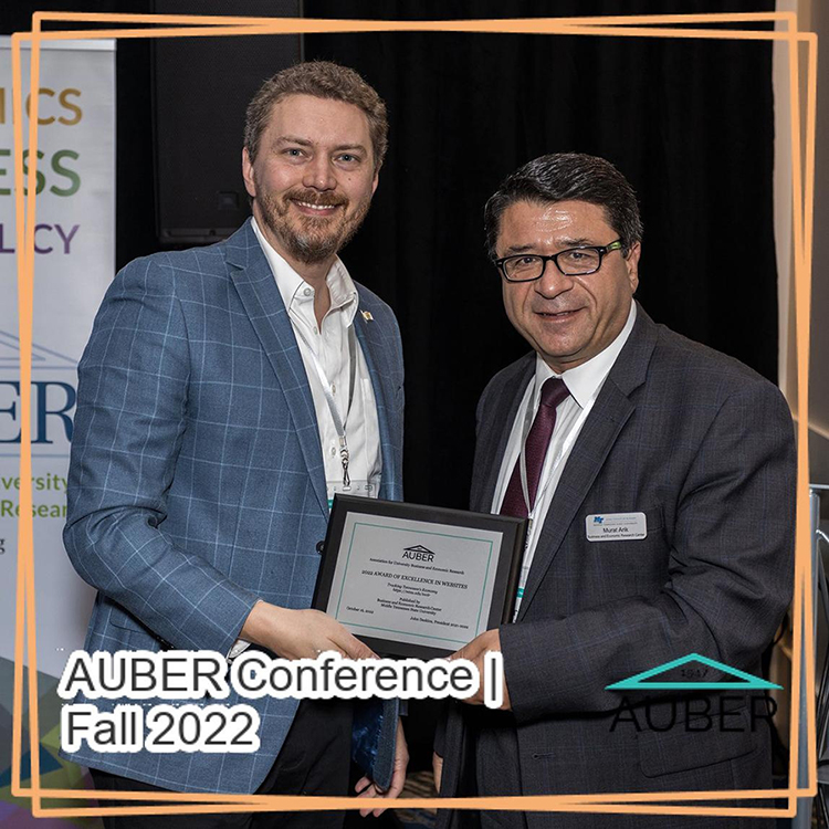 Murat Arik, right, director of the Business and Economic Research Center at Middle Tennessee State University, accepts the National AUBER 2022 Award of Excellence in Websites from the Association for University Business and Economic Research, or AUBER, at the organization's fall conference in October. AUBER is a national professional organization for business and economic research centers. (Submitted photo)