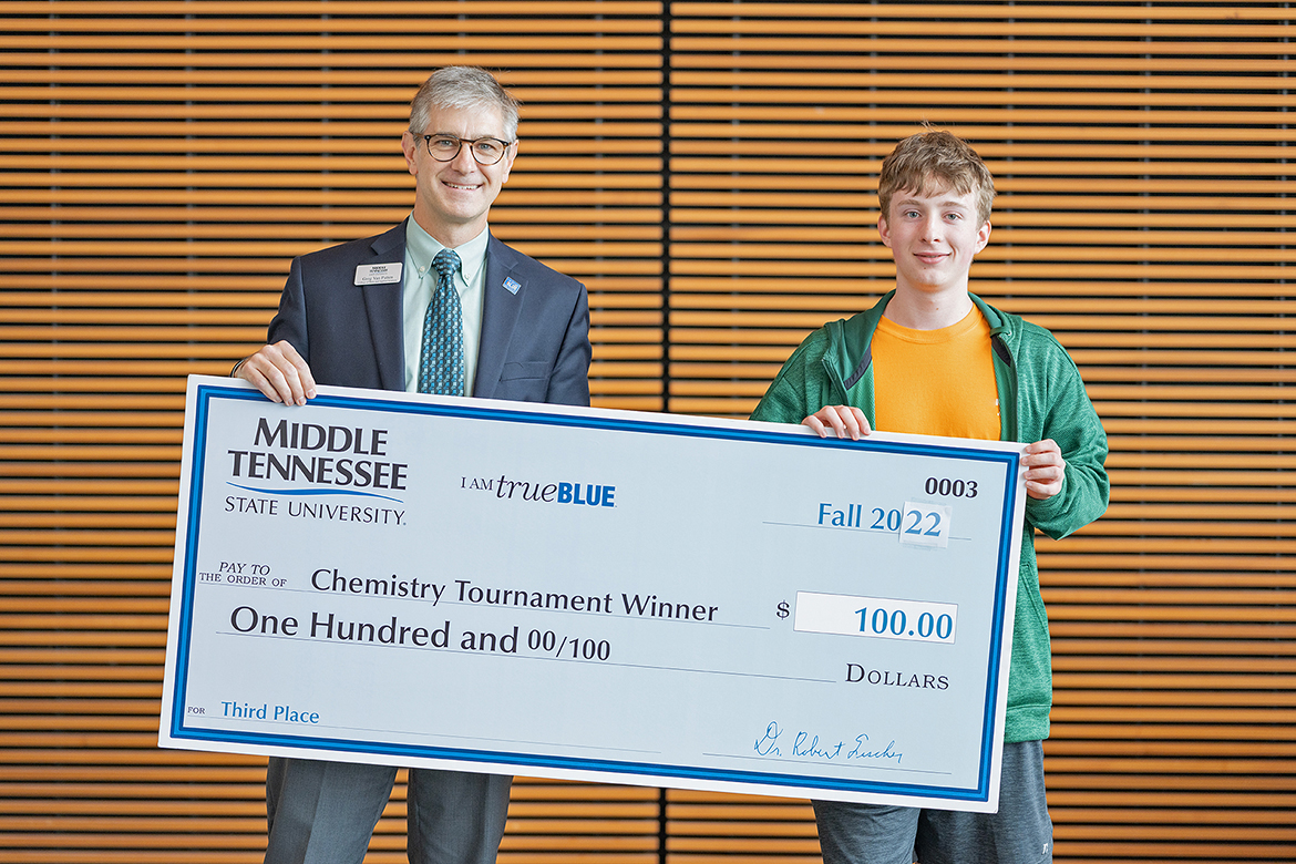 Middle Tennessee State University College of Basic and Applied Sciences Dean Greg Van Patten, left, presents the 2022 Chemistry Tournament’s top junior finisher, Jack Stinson of Spring Hill, Tenn., and Summit High School, with his $100 cash award in early November in the MTSU Science Building. Outstanding high school chemistry students from across the region and even one from Georgia participated in the event this year. (MTSU photo by Cat Curtis Murphy)