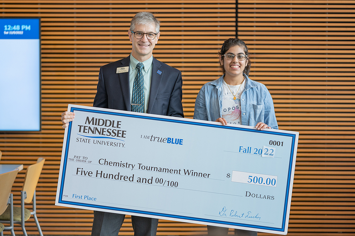 Middle Tennessee State University College of Basic and Applied Sciences Dean Greg Van Patten, left, presents the 2022 Chemistry Tournament’s overall winner, Ashima Grover of Franklin, Tenn., and Ravenwood High School with her $500 cash award in early November in the MTSU Science Building. Top high school chemistry students from across the region and even one from Georgia participated in the event. (MTSU photo by Cat Curtis Murphy)