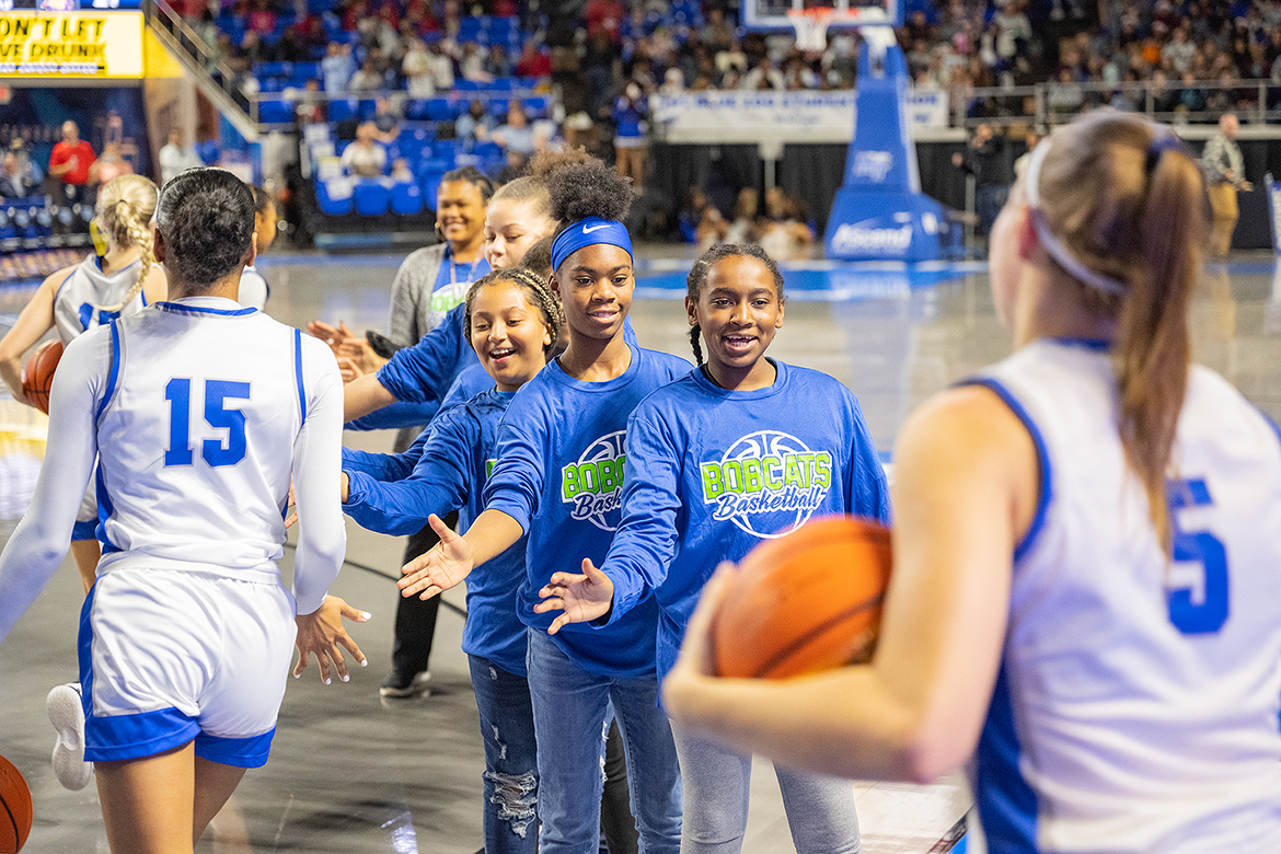 Bradley Academy students give Middle Tennessee State University Lady Raiders’ players high fives as they enter the court before the start of the MTSU-Tennessee Tech women’s college basketball game Thursday, Dec. 1, in Murphy Center.  MTSU won the nonconference game, 83-45. (MTSU photo by Cat Curtis Murphy)