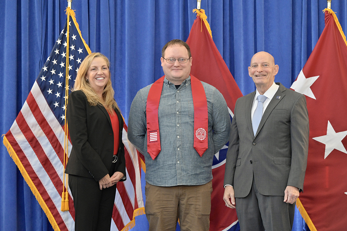 Amazon’s Ellen Moore, left, and Middle Tennessee State University’s Keith M. Huber, right, congratulate Derrick Blackburn of Florence, Ala., one of more than 40 student veterans attending the Graduating Veterans Stole Ceremony Wednesday, Nov. 30, in the Andrew Woodfin Miller Sr. Education Center second-floor atrium on Bell Street. Blackburn, who will be graduating Dec. 10 in Murphy Center, is a finance major. Moore is senior program manager in Workforce Staffing at Amazon in Nashville and a retired U.S. Air Force brigadier general. A retired U.S. Army lieutenant general, Huber served 38 years in the military and is the university’s senior adviser for veterans and leadership initiatives. (MTSU photo by Andy Heidt)