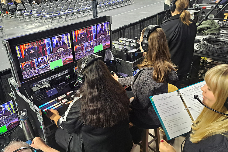 True Blue TV Event Productions student worker Helen Grace Daniel, right, follows the script and gives out directions as the director for the first time during the morning ceremony of the 2022 Fall Commencement on Dec. 10 inside Murphy Center. (MTSU photo by Jimmy Hart)