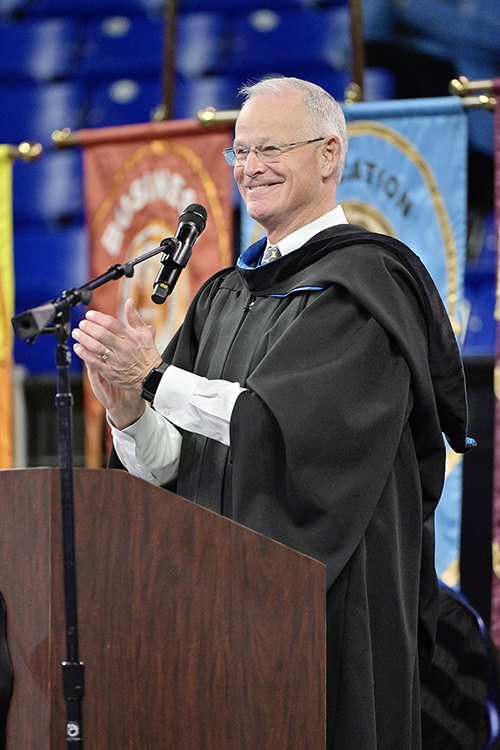 Doug Kreulen, president and chief executive officer of the Metropolitan Nashville Airport Authority, applauds the fall Class of 2022 at Middle Tennessee State University while serving as guest speaker for its Dec. 10 morning commencement ceremony in Hale/Earle Arena inside Murphy Center. MTSU presented 1,698 students with their degrees — 1,345 undergraduates and 353 graduate students — to mark the first graduation of its 112th academic year. (MTSU photo by Andy Heidt)