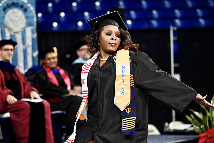 A member of MTSU's fall Class of 2022 does a little dance of joy and relief as she returns to her seat, nursing degree in hand, in Hale/Earle Arena inside Murphy Center during the university's Dec. 10 commencement ceremonies. MTSU presented 1,698 students with their degrees — 1,345 undergraduates and 353 graduate students — to mark the first graduation of its 112th academic year. (MTSU photo by James Cessna)