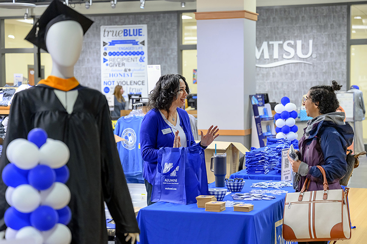 MTSU graduating senior Mary Guirguis, right, a professional computer science major from Antioch, Tenn., laughs while talking with Kristen Janson, assistant director of alumni relations, during the university's Senior Celebration inside Phillips Bookstore in the Student UnionDec. 5. Students graduating Saturday, Dec. 10, in MTSU's fall 2022 commencement ceremonies were able to pick up regalia and small gifts and learn about the university's Senior Gift Program for scholarships and other development needs, alumni services and career development. (MTSU photo by J. Intintoli)