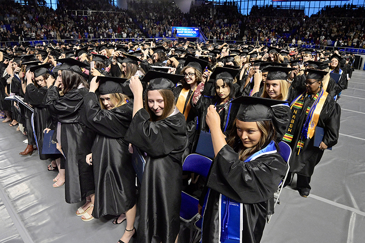 Members of MTSU's fall Class of 2022 prepare to move their mortarboard tassels from right to left to signify their successful graduation during the university's Dec. 10 commencement ceremonies in Hale/Earle Arena inside Murphy Center. MTSU presented 1,698 students with their degrees — 1,345 undergraduates and 353 graduate students — to mark the first graduation of MTSU's 112th academic year. (MTSU photo by Andy Heidt)