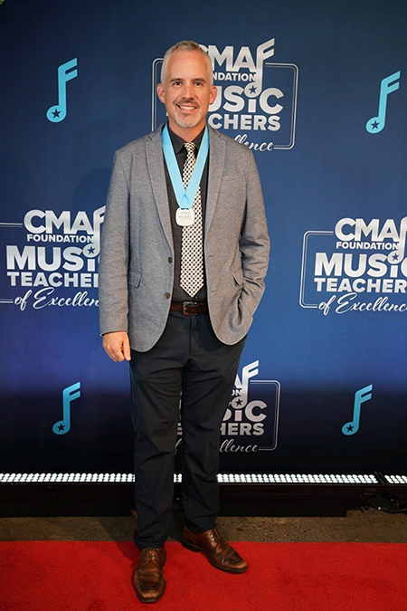 John Hazlett, graduate music alumna from Middle Tennessee State University and band director for McGavock High School in Nashville, Tenn., attended the CMA Foundation Music Teacher of Excellence awards ceremony at Marathon Music Works in Nashville, in October 2022, to receive his prize for his third win as a music teacher of excellence. (Photo courtesy of John Hazlett)