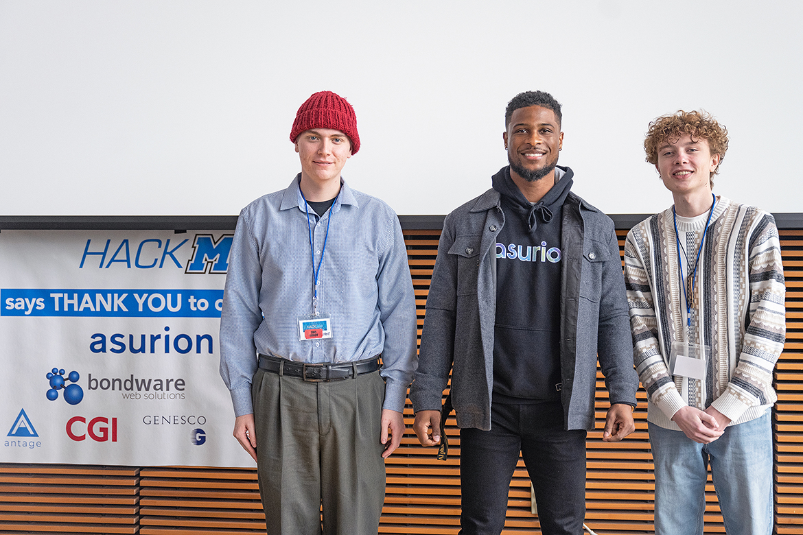 Middle Tennessee State University computer science majors Wesley Mitchell, left, and Ian Tatum, right, received $2,500 scholarships from event sponsor Asurion Sunday, Jan. 29, at the conclusion of the annual MTSU HackMT event in the Science Building. Kevon Young, software engineer with Asurion, announced the names of the winners. (MTSU photo by Cat Curtis Murphy)