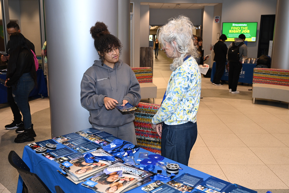 Middle Tennessee State University Recording Industry professor Amy Macy, right, shows music business options to Mia Bush, 17, a La Vergne High School senior performing dual enrollment with Motlow State Community College Tuesday, Jan. 24, during the kickoff to the 2023 MTSU Promise Tour to recruit transfer and future students to the university. Dozens of Motlow students attended the three-hour visit by MTSU faculty and staff. (MTSU photo by James Cessna)