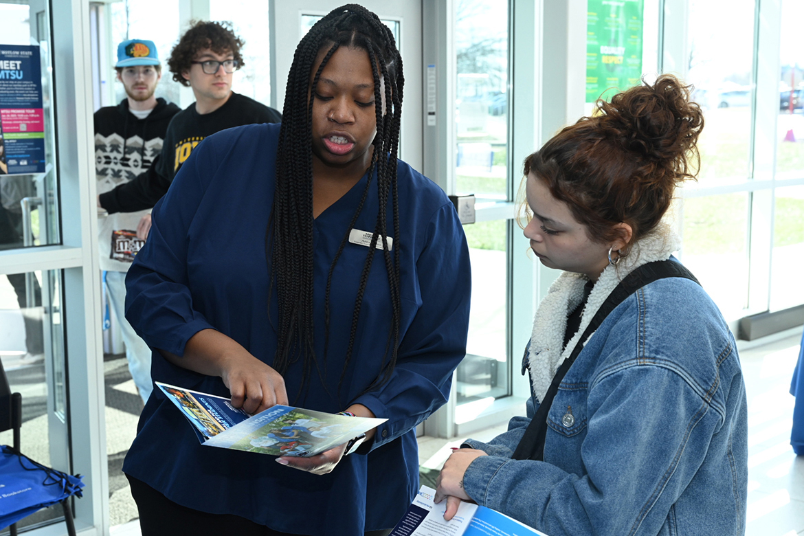 Anna Goins, left, Middle Tennessee State University enrollment coordinator in undergraduate recruitment, assists a Motlow State Community College student attending the kickoff to the 2023 MTSU Promise Tour in January 2023 in Smyrna, Tenn. MTSU will kick off the 2024 Promise Tour Tuesday, Jan. 30, at Motlow. The event is scheduled from 10 a.m. to 1 p.m. (MTSU file photo by James Cessna)