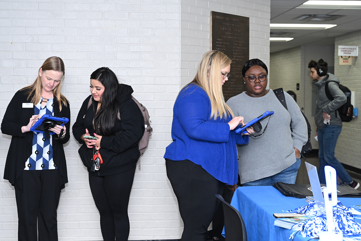 Tara Wallace, left, and Rebecca Darden, second from right, Middle Tennessee State University enrollment coordinators in  undergraduate recruitment, gather information from two Volunteer State Community College students attending the MTSU Promise Tour Wednesday, Jan. 24, in Gallatin, Tenn. MTSU Admissions staff and faculty are recruiting prospective transfer students at nine community colleges, in time for them to meet the Feb. 15 deadline to receive a guaranteed scholarship ($3,000 per year) if they qualify.  (MTSU photo by James Cessna)
