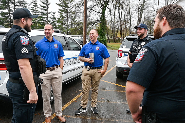 Staff at Middle Tennessee State University’s Police Department help two of its newest hires, Tristan Slater, second from left, and Lealand Wood, center, feel like a part of the department’s family through moments of camaraderie and conversation in November 2022 on campus. (MTSU photo by Stephanie Wagner)