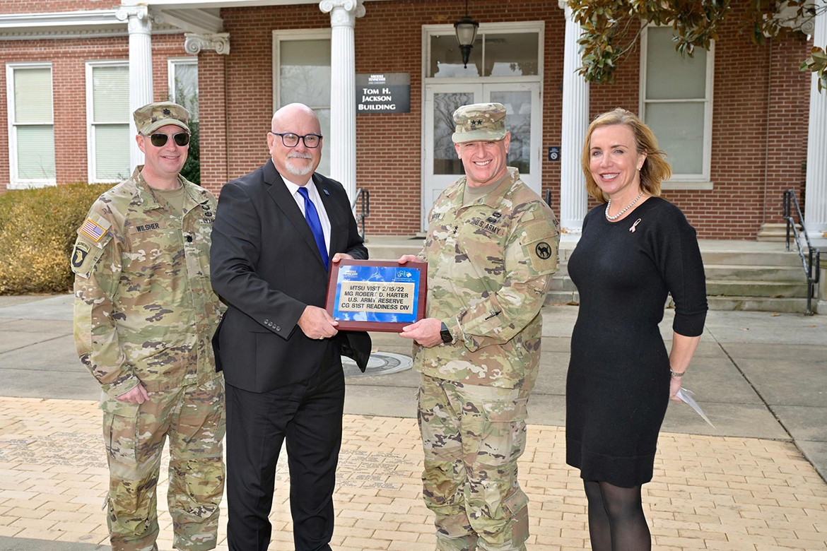Army Reserve Maj. Gen. Bob D. Harter, second from right, accepts an engraved brick from Middle Tennessee State University representatives during a brief ceremony at the university’s Veterans Memorial commemorating his visit Wednesday, Feb. 15. Pictured, from left, are U.S. Army Lt. Col. Arlin Wilsher, professor in the MTSU Department of Military Science; Andrew Oppmann, MTSU vice president for marketing and communications and an Army Reserve ambassador; Harter; and Hilary Miller, director of the Charlie and Hazel Daniels Veterans and Military Family Center at MTSU. (MTSU photo by Andy Heidt)