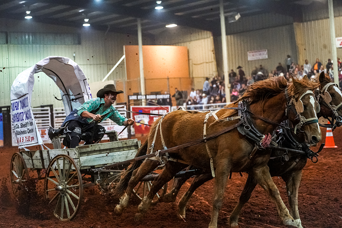 As part of the fun from the Lone Star Rodeo, a wagon driver uses a whip to get the horses to run faster at one of the benefit events on the rodeo circuit. Tennessee Miller Coliseum hosts the rodeo at 7 p.m. Friday and Saturday, March 3-4, to benefit the Community Foundation of Rutherford County. (Photo by Haley Johnson Photography)