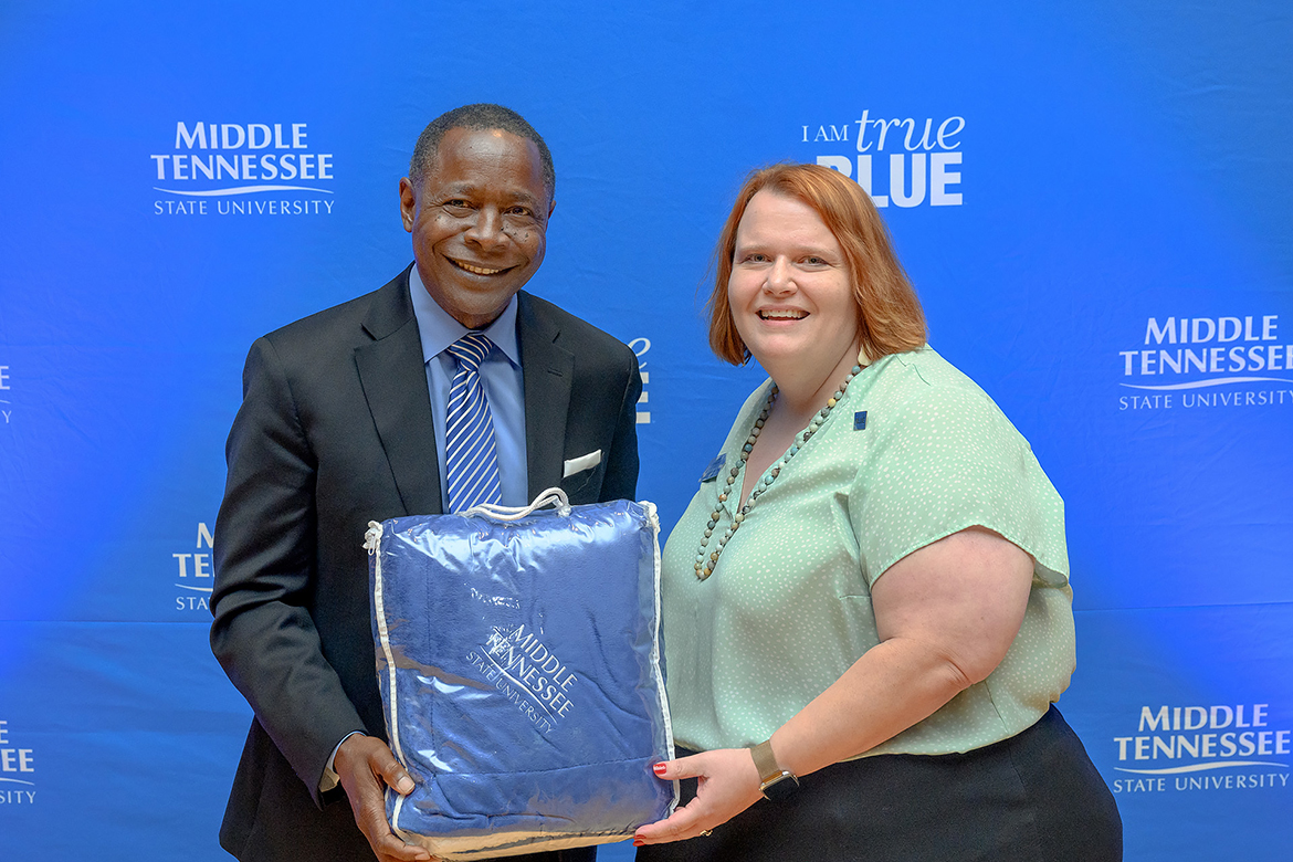 Amy Aldridge Sanford, right, receives a gift from Middle Tennessee State University President Sidney A. McPhee during the 2022 Tenure and Promotion reception in the James Union Building's Tennessee Room. Sanford, vice provost for Academic Programs in the Provost's Office and professor of Communications Studies, will receive the Jack Kay Award for Community Engagement and Applied Communication Scholarship — a major regional honor from the 13-state Central States Communication Association — in March in St. Louis, Mo. (MTSU file photo by Andy Heidt)