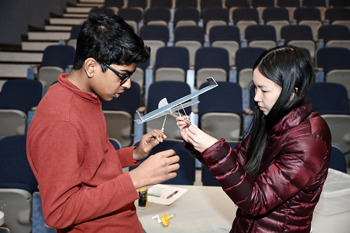 Ravenwood High School teammates Chetan Yenigalla, left, and Sophia Wang check the airplane they created, designed and flew after one of its landings, as part of the 28th annual Regional Science Olympiad held Saturday, Feb. 18, at Middle Tennessee State University. Their effort helped the Brentwood, Tenn., high school earn first-place honors and advance to the April 1 Science Olympiad State Tournament at the University of Tennessee-Knoxville. (MTSU photo by James Cessna)
