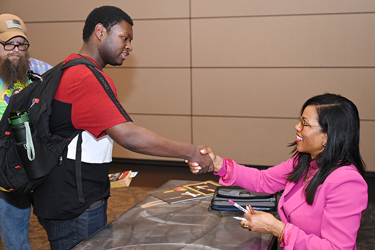 MTSU Shabazz keynote 3: Author and educator Ilyasah Shabazz, right, shakes hands with an audience member while another waits his turn during a book-signing event after her keynote address Monday, Feb. 27, in the Student Union’s ballroom to conclude Middle Tennessee State University’s 2023 Black History Month activities. (MTSU photo by James Cessna)