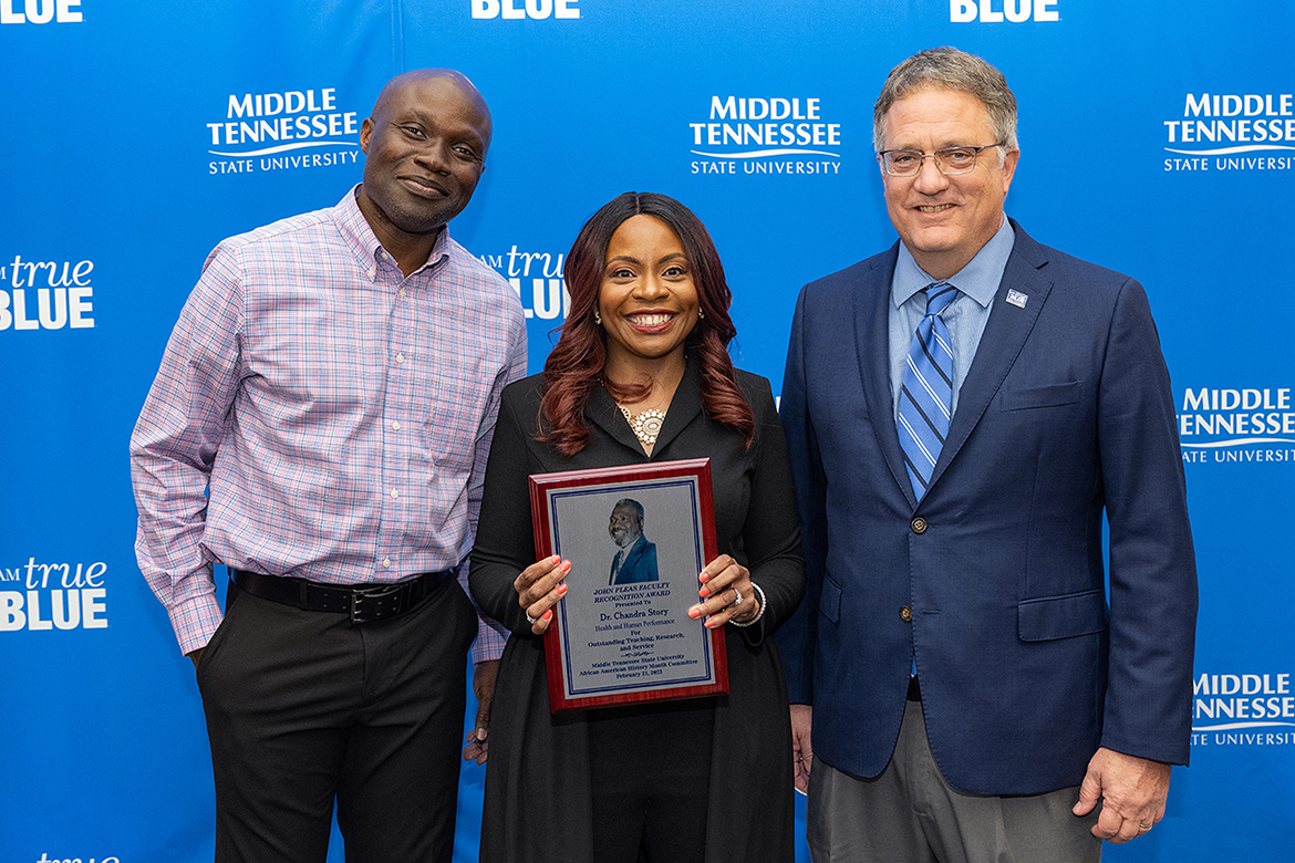 MTSU Health and Human Performance professor Chandra Russell Story, center, holds the 2023 John Pleas Faculty Recognition Award presented to her Tuesday, Feb. 21, during a special ceremony at the Ingram Building’s MT Center. Pictured with her are MTSU Provost Mark Byrnes, right, and Andrew Owusu, Health and Human Performance professor and the 2022 Pleas Award recipient. The award is the highest honor for MTSU’s Black faculty. (MTSU photo by Cat Curtis Murphy)