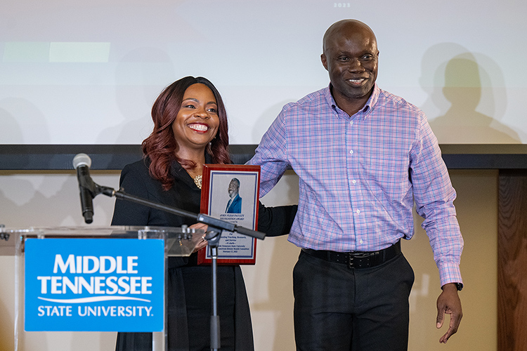 Andrew Owusu, Health and Human Performance professor and the 2022 John Pleas Faculty Recognition Award recipient, right, poses for a photo with fellow MTSU Health and Human Performance professor Chandra Russell Story after presenting her with the 2023 Pleas Award on Tuesday, Feb. 21, during a special ceremony at the Ingram Building’s MT Center. (MTSU photo by Cat Curtis Murphy)