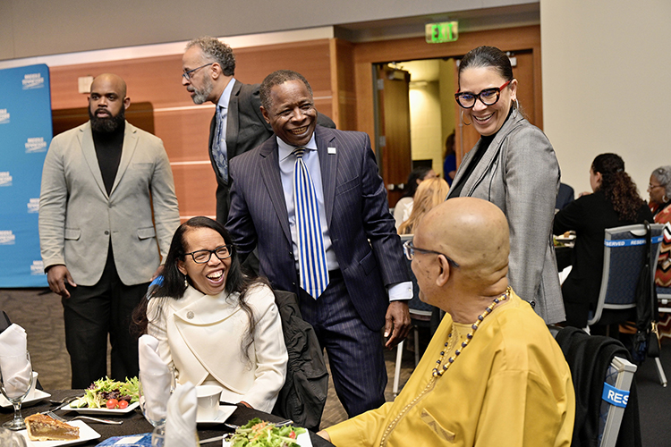 Middle Tennessee State University President Sidney A. McPhee, center, chats with “unsung hero” honoree for education and retired MTSU professor Marva Lucas, seated at left, and her husband, Marcus, seated right, at the 27th annual Unity Luncheon held Wednesday, Feb. 8, at the Student Union Building. At right, standing, is Monica Smith, assistant to the president for community engagement and inclusion. In the background, at left, are MTSU professor Aaron Treadwell, far left, and Vincent Windrow, MTSU’s former associate vice provost for student success. (MTSU photo by Andy Heidt)