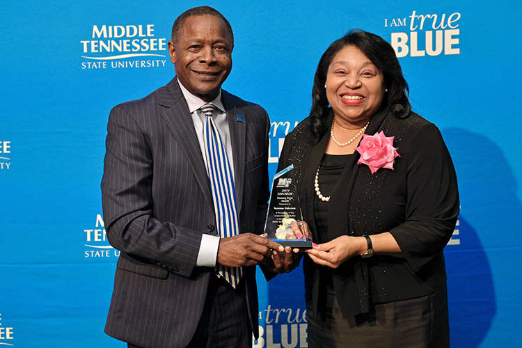 Middle Tennessee State University President Sidney A. McPhee, left, presents alumna Vanessa Alderson with the “unsung hero” award for contribution to Black art at the 27th annual Unity Luncheon held Wednesday, Feb. 8, at the Student Union Building. (MTSU photo by Andy Heidt)