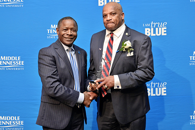 Middle Tennessee State University President Sidney A. McPhee, left, presents alumnus Michael McDonald with the “unsung hero” award as an advocate for civility at the 27th annual Unity Luncheon held Wednesday, Feb. 8, at the Student Union Building. (MTSU photo by Andy Heidt)