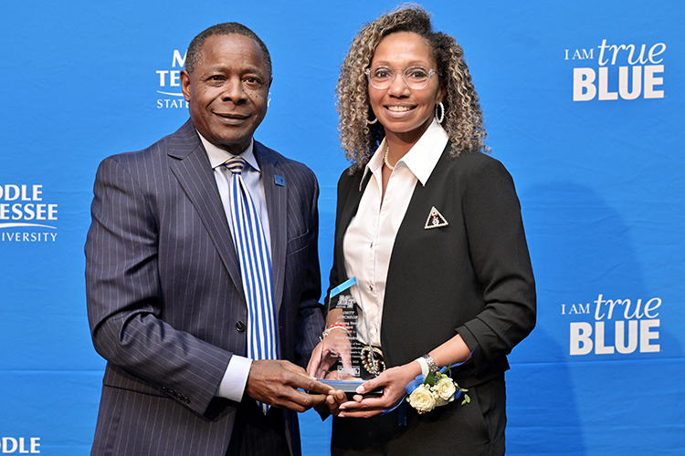 Middle Tennessee State University President Sidney A. McPhee, left, presents alumna Stacy Windrow with the “unsung hero” award for excellence in sports at the 27th annual Unity Luncheon held Wednesday, Feb. 8, at the Student Union Building. (MTSU photo by Andy Heidt)