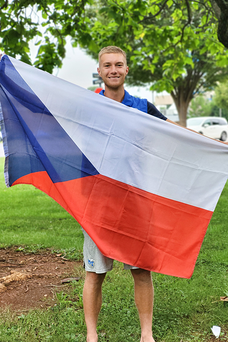 Pavel Motl, graduate student at Middle Tennessee State University and member of the International Student Council on campus, holds up his home country’s flag, the Czech Republic, at a council event in fall 2022 outside of the Jones Hall Building on campus. (Photo courtesy of Pavel Motl)