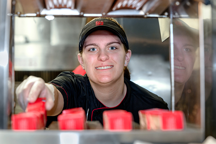 Middle Tennessee State University student and Murfreesboro Chick-fil-A employee Kaylin Garton, shown here inside one of the Murfreesboro locations in this 2022 file promotional photo, is among employees taking advantage of a partnership between the Noblitt family, owners of the local restaurant, and the university that provides tuition assistance to qualifying Chick-fil-A employees. (MTSU file photo by J. Intintoli)