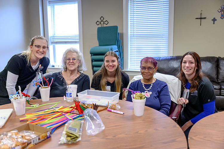 Middle Tennessee State University School of Nursing students Barbara Frizzell, far left, Insa Feldhusen, center, and Kaitlyn Becksted, far right, complete a crafting activity with members of the local Mindful Care adult day program as part of a new partnership between the nonprofit and students in the Health and Gerontology course on March 13, 2023, in Murfreesboro, Tenn. (MTSU photo by J. Intintoli)