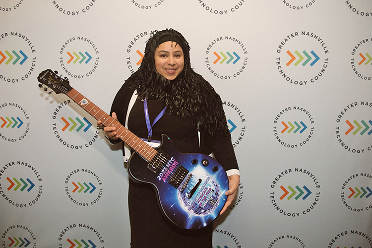 Sam Zaza, assistant professor in the MTSU Department of Information Systems and Analytics, holds the guitar award she received for being named the Greater Nashville Technology Council’s Diversity and Inclusion Advocate of the Year at the NTC Awards ceremony held Feb. 16 at the Wildhorse Saloon in Nashville, Tenn. (Photo courtesy of the Greater Nashville Technology Council)