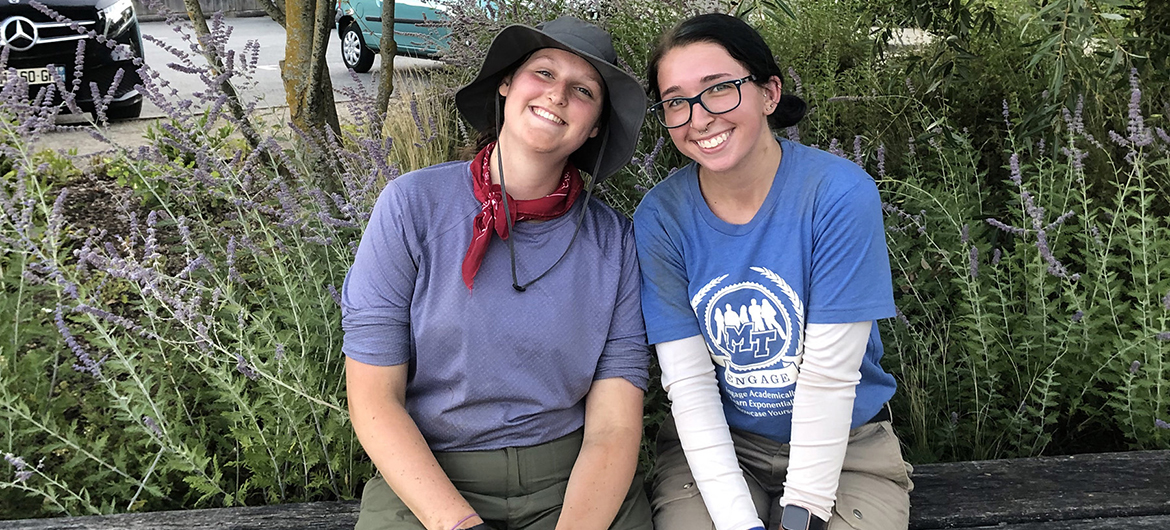 Audrey Lauerhass, Middle Tennessee State University forensic science and anthropology student, left, poses with MTSU student Tori Bascou, both in their field clothes after a long day of work on a recovery site in France as part of the MTSU Forensic Aviation Archaeology study abroad course in summer 2022. (Photo courtesy of Audrey Lauerhass)