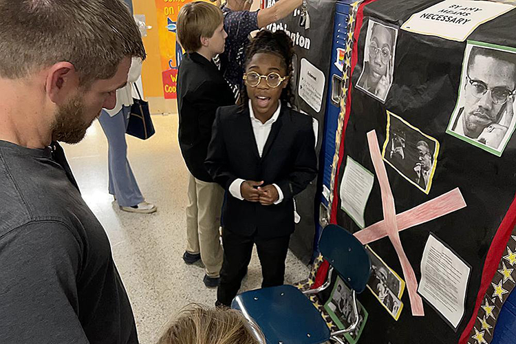 A Homer Pittard Campus School fifth grader explains his living history project about human rights activist Malcolm X on Tuesday, April 11, during the Campus School Open House event at its Lytle Street location. The laboratory teacher training school is a partnership between RCS and Middle Tennessee State University. (Photo courtesy of James Evans, Rutherford County Schools)