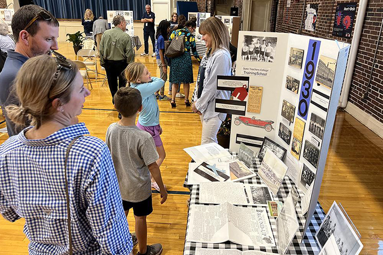 Homer Pittard Campus School students and parents visit one of the historical displays in the school's gymnasium Tuesday, April 11, during the school's open house at its Lytle Street location. The laboratory teacher training school is a partnership between RCS and Middle Tennessee State University. (Photo courtesy of James Evans, Rutherford County Schools)