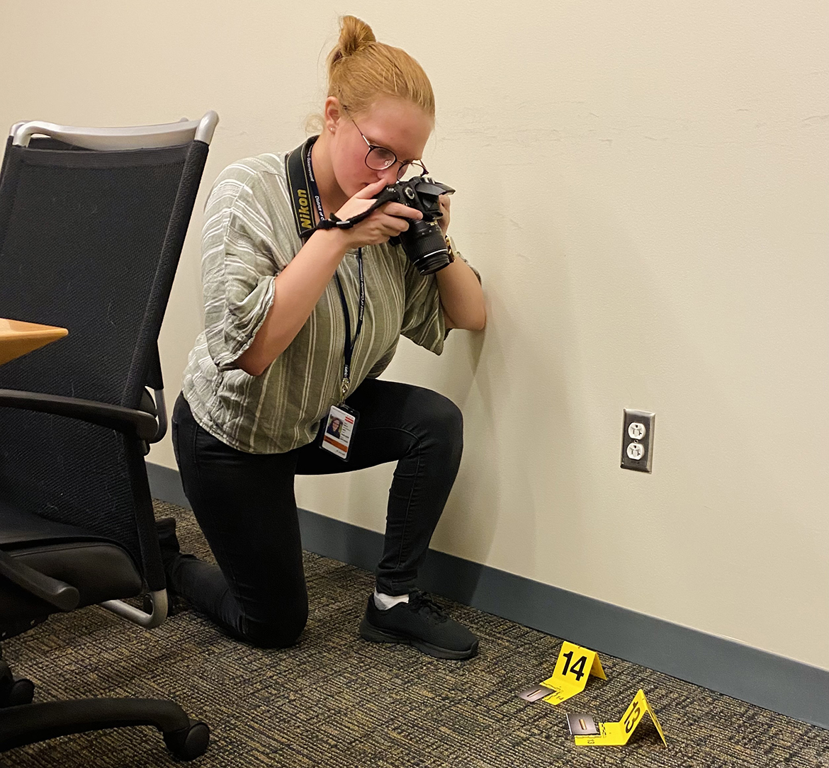 As part of U.S. Department of Forensic Science internship in the summer of 2022, Middle Tennessee State University senior Elizabeth Kowalczyk of Huntsville, Ala., takes photos at a mock crime scene, with bullet recovery depicted in the image. Kowalczyk was recently named a 2023 Goldwater Scholar by the Barry Goldwater Scholarship and Excellence in Education Foundation. The award encourages outstanding undergraduate students to pursue careers in science, technology, engineering and mathematics research. (Submitted photo)