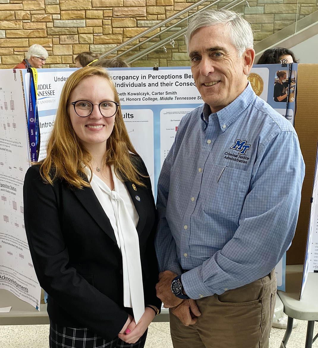 Middle Tennessee State University senior Elizabeth Kowalczyk, left, of Huntsville, Ala., and Carter Smith, assistant professor in MTSU Criminal Justice Administration attend the College of Basic and Applied Sciences’ Scholars Day as part of the universitywide Scholars Week in March in the Science Building’s Liz and Creighton Rhea Atrium. Smith was Kowalczyk’s adviser on her award-winning poster titled “Understanding the Discrepancy in Perceptions Between Forensic Experts and Lay Individuals and their Consequences.” (Photo by Allison Kowalczyk)