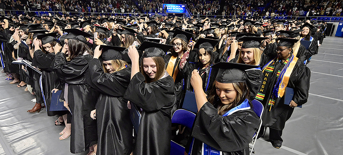 Members of Middle Tennessee State University's fall Class of 2022 prepare to move their mortarboard tassels from right to left to signify their successful graduation during the university's Dec. 10 commencement ceremonies in Hale/Earle Arena inside Murphy Center. MTSU will award degrees to 2,658 prospective graduates during four spring 2023 commencement ceremonies planned over Friday and Saturday, May 5-6. (MTSU file photo by Andy Heidt)