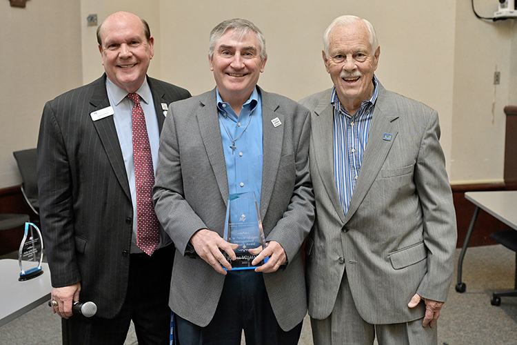 E.W. “Wink” Midgett Distinguished Research Award recipient Ralph Williams, center, associate professor, MTSU Department of Management, accepts his award from Jones College of Business Dean David Urban, left, and longtime college supporter Don Midgett, son of the late E.W. “Wink” Midgett, during an awards ceremony April 14 in the State Farm Lecture Hall inside the Business and Aerospace Building at Middle Tennessee State University. (MTSU photo by Andy Heidt)