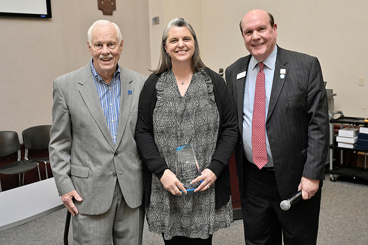 E.W. “Wink” Midgett Outstanding Staff Member award recipient Emily Madison, center, executive assistant, MTSU Department of Marketing, accepts her award from Dean David Urban, right, and longtime college supporter Don Midgett, son of the late E.W. “Wink” Midgett, during an awards ceremony April 14 in the State Farm Lecture Hall inside the Business and Aerospace Building at Middle Tennessee State University. (MTSU photo by Andy Heidt)