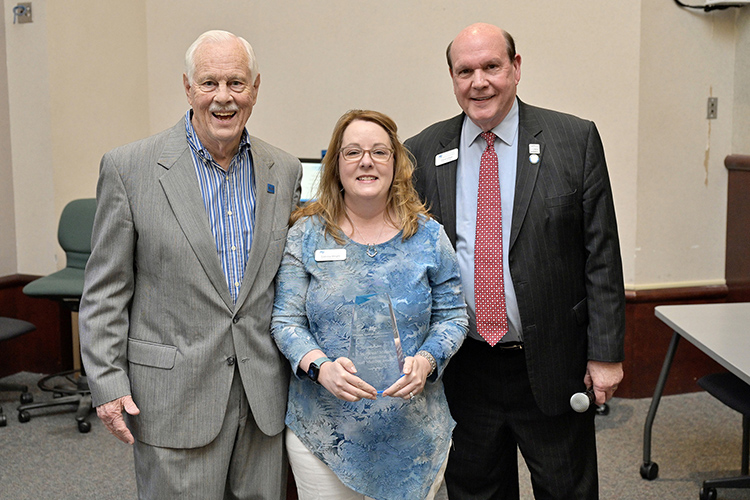 E.W. “Wink” Midgett Outstanding Staff Member award recipient Sabrina Wright, center, financial administrator in the Jones College of Business Dean’s Office, accepts her award from Jones College of Business Dean David Urban, right, and longtime college supporter Don Midgett, son of the late E.W. “Wink” Midgett, during an awards ceremony April 14 in the State Farm Lecture Hall inside the Business and Aerospace Building at Middle Tennessee State University. (MTSU photo by Andy Heidt)