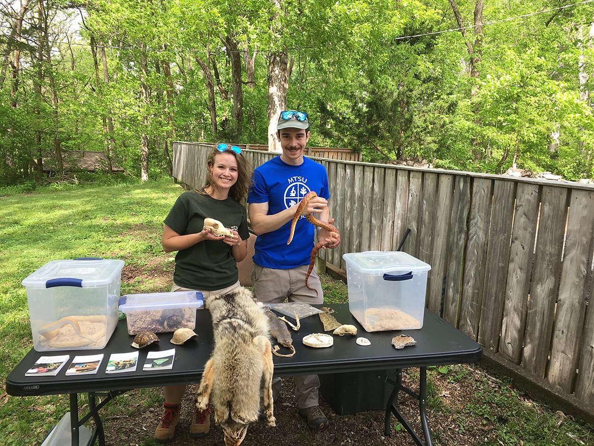 Former Middle Tennessee State University graduate student Bekkah Riley, left, and MTSU biology research scientist Alex Romer man the animal table at the 2022 Elsie Quarterman Cedar Glade Wildlife Festival at Cedars of Lebanon State Park. Children of all ages can hold snakes, turtles and artifacts found in the glades near the park. This year’s festival will be held Friday and Saturday, May 5-6. (Submitted photo)