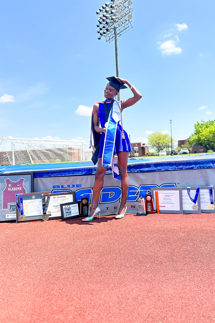 Abigail Kwarteng, Middle Tennessee State University recent graduate and Olympic hopeful, poses in Floyd Stadium on campus with her multiple track-and-field trophies, medals and plaques on the day of her commencement from the university’s Master of Public Health program, Saturday, May 6. (Photo courtesy of Abigail Kwarteng)