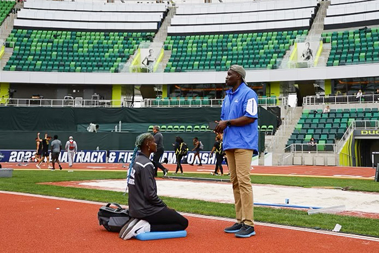 Abigail Kwarteng, left, recent graduate from Middle Tennessee State University and Olympic hopeful, debriefs with her coach Andrew Owusu, MTSU public history professor and multi-time Olympian himself, at her final NCAA track-and-field competition at Hayward Field track at the University of Oregon in Eugene, Ore., in the summer of 2022. (Photo courtesy of Abigail Kwarteng)