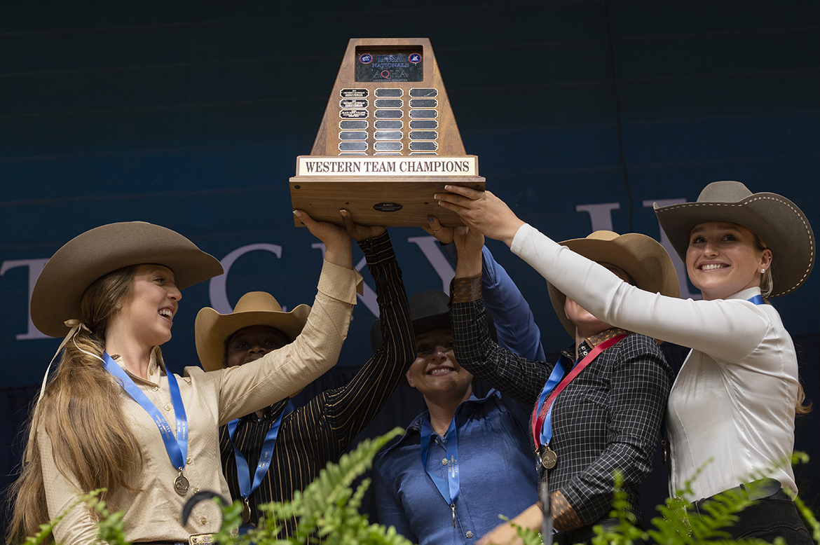 Middle Tennessee State University equestrian team members, from left, Audrey Ferrie, Sadio Barnes, Mackenzie Latimer, Jordan Martin and Jessie Kauffman hoist the Intercollegiate Horse Shows Association Western championship trophy into the air May 7 at Kentucky Horse Park in Lexington, Ky. It marks the first national championship for MTSU riders. (Photo by Danielle Dunn)