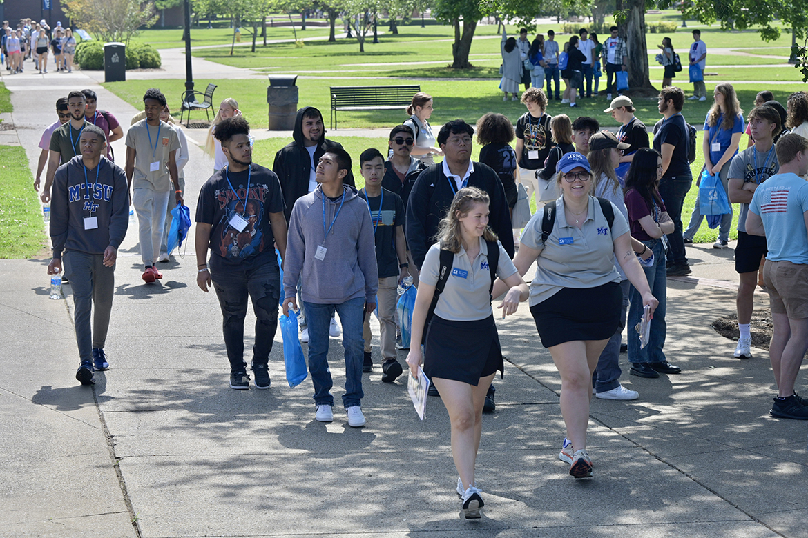 Walking past Todd Hall and toward Peck Hall, Middle Tennessee State University student orientation assistants, or SOAs, lead a group of new students during CUSTOMS orientation in May, just before they break for lunch. (MTSU photo by Andy Heidt)