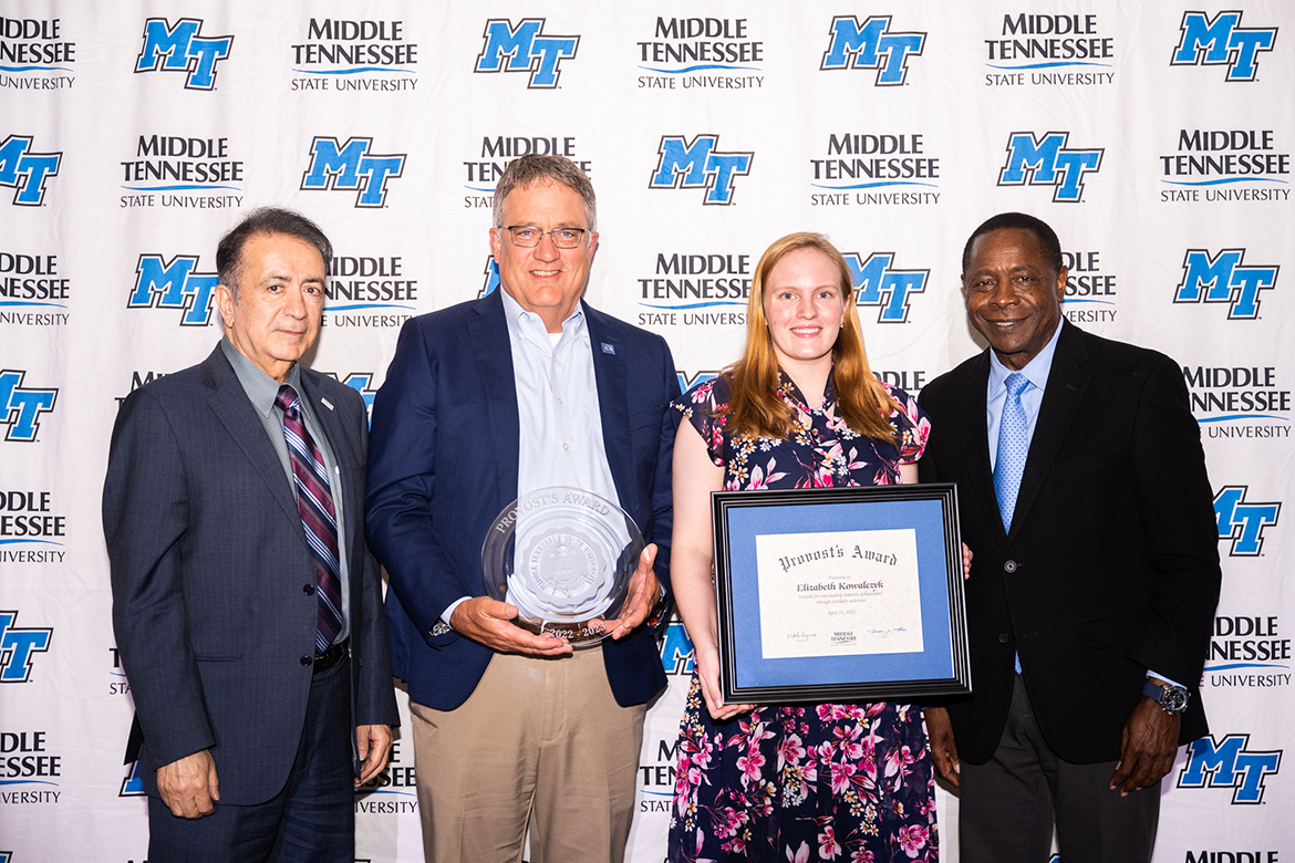 Middle Tennessee State University senior Elizabeth Kowalczyk, second from right, of Huntsville, Ala., receives the 2022-23 Provost’s Award April 24 during the SGA and Center for Student Involvement and Leadership Awards Banquet. Also pictured are Saeed Foroudastan, left, College of Basic and Applied Sciences associate dean; Provost Mark Byrnes; and President Sidney A. McPhee. (MTSU photo by James Cessna)