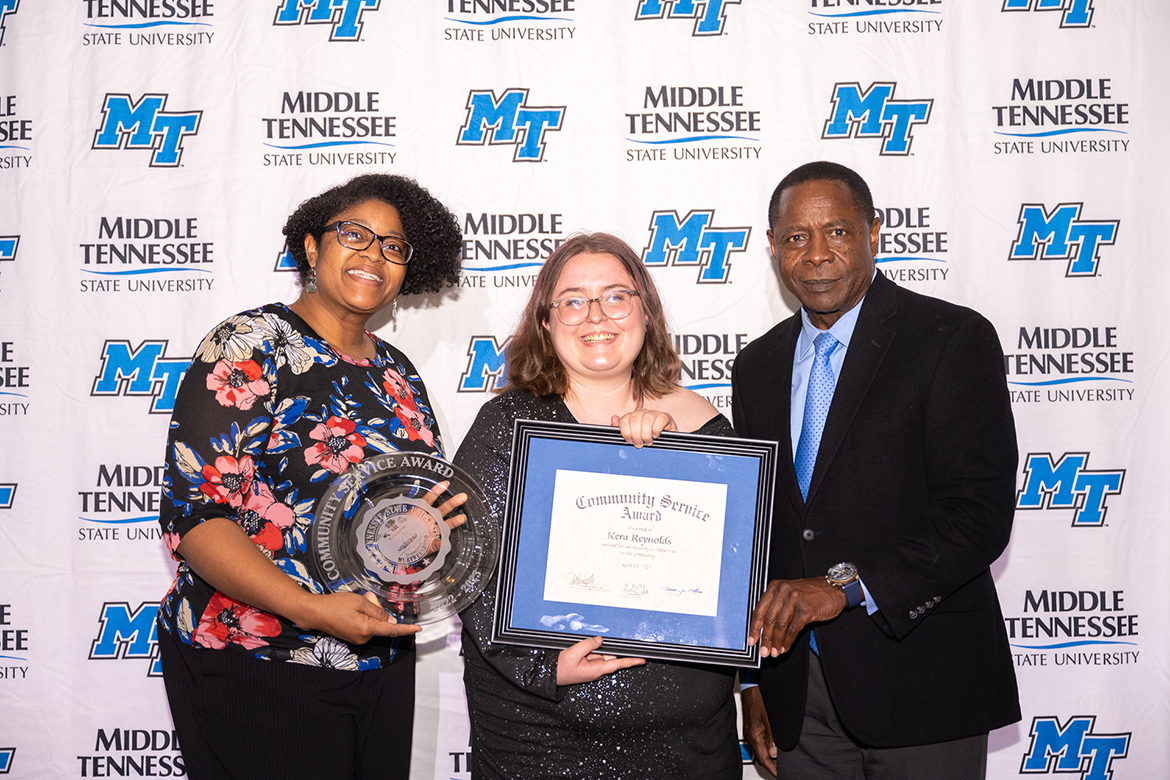 Middle Tennessee State University student Kera Reynolds, center, receives the Community Service Award from MTSU President Sidney A. McPhee, right, and College of Liberal Arts Dean Leah Lyons April 24 during the annual SGA and Center for Student Involvement and Leadership, held in the Student Union Ballroom. The award is given to a student who has made an outstanding contribution to the community. (MTSU photo by James Cessna)