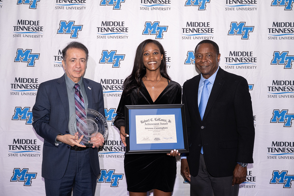 
Middle Tennessee State University senior Brioanna Cunningham, center, receives the Robert C. LaLance Jr. Award from MTSU President Sidney A. McPhee, right, and Saeed Foroudastan, College of Basic and Applied Sciences associate dean, April 24 at the SGA and Center for Student Involvement and Leadership Awards Banquet in the Student Union Ballroom. This award honors a student who has shown remarkable determination, has had to make sacrifices and is contributing to the community while working toward a degree. (MTSU photo by James Cessna)