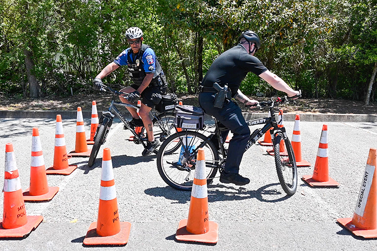 Master Patrol Officer Leroy Carter, left, of Middle Tennessee State University’s Police Department guides an officer from the Rutherford County Sheriff’s Office through an obstacle during the first of three bike patrol training classes put on by MTSU Police for its officers and officers from surrounding departments on May 3, 2023, on campus. (MTSU photo by Stephanie Wagner)