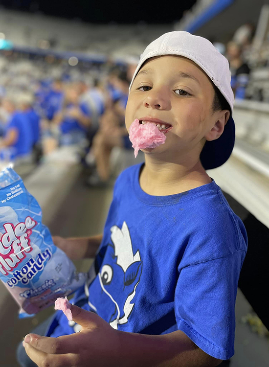 In this undated photo, Ben Storey, the youngest son of MTSU alumnus and EMT Scott Storey (Class of 2017) of Mt. Pleasant, Tenn., enjoys a treat during a Blue Raider football game at Floyd Stadium. Storey’s father earned his bachelor’s degree in professional studies through MTSU Online. (Submitted photo)